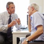 Senior Patient Having Consultation With Doctor In Office